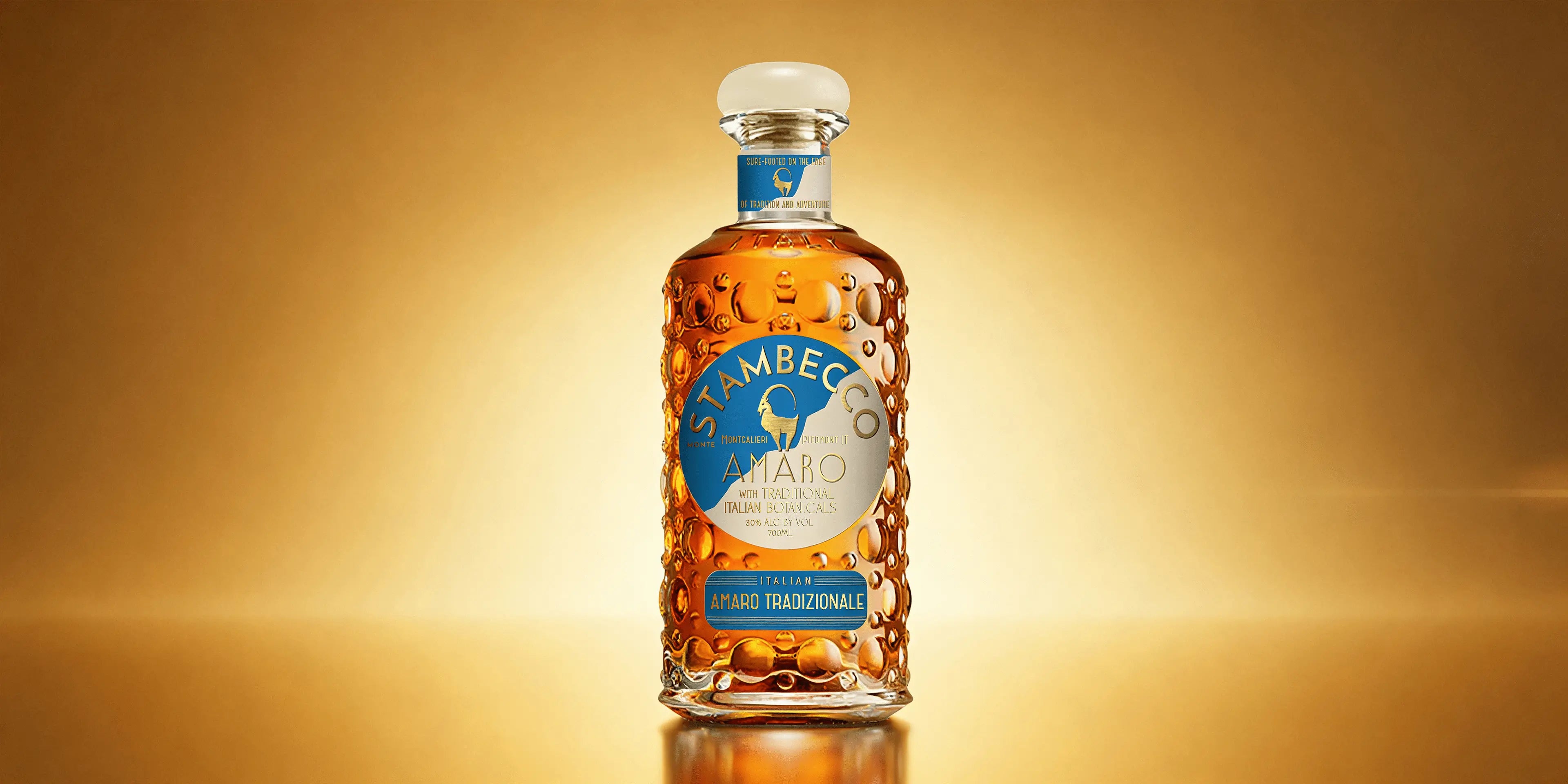 A bottle of Stambecco Amaro Tradizionale on a gold background